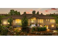 Charming exterior of a home featuring stone accents and a lush, professionally landscaped front yard at 276 Ember Pl, Castle Rock, CO 80104