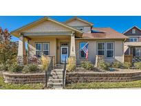 Charming home featuring a covered porch, landscaped yard, and classic architectural details at 149 Jewel St, Brighton, CO 80603