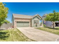 Charming single Gathering home with brick accents, attached garage, and mature landscaping at 19771 E Wesley Pl, Aurora, CO 80013