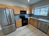 Modern kitchen featuring stainless steel appliances and granite countertops at 23465 E Platte Dr # E, Aurora, CO 80016