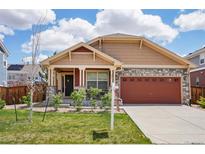 Charming single-Gathering home with manicured lawn, stone accents, and a two-car garage at 464 N Jamestown Way, Aurora, CO 80018
