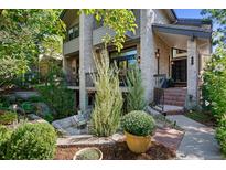 Inviting brick home with a well-manicured front yard and charming front patio at 210 N Garfield St, Denver, CO 80206