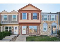 Charming townhome with a stone facade, complemented by colorful accents and a well-maintained lawn at 2991 W 81St Ave # G, Westminster, CO 80031