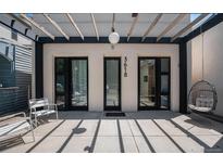 Inviting front entrance featuring a pergola, modern lighting, and stylish black framed doors at 3618 Navajo St, Denver, CO 80211
