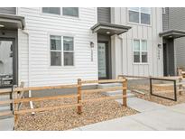 Charming townhome entrance featuring a covered doorway and attractive landscaping at 3458 W 63Rd Ave, Denver, CO 80221