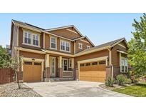 Charming two-story home featuring a three-car garage, brick accents, and a well-manicured front yard at 10045 Copenhagen St, Parker, CO 80134