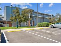 Condo with multiple levels, stairs, balconies, and parking; featuring muted blues and gray exterior at 3141 S Tamarac Dr # 206E, Denver, CO 80231