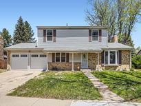 Charming two-story home featuring a well-maintained lawn and a convenient two-car garage at 14665 E Stanford Pl, Aurora, CO 80015