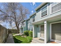 Charming, light-blue townhome with landscaped front yard and welcoming entrance at 12125 Bannock St # C, Westminster, CO 80234