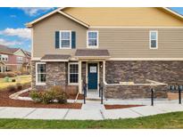 Charming home featuring a stone facade, a welcoming entryway, and a cozy porch area at 12744 Leyden St # F, Thornton, CO 80602