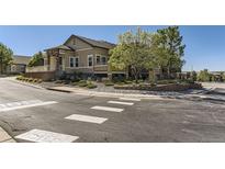 Inviting home featuring professionally landscaped front yard and stylish architectural details like stone columns and multi-level terraces at 6655 S Shawnee St, Aurora, CO 80016