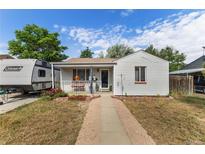 Charming home with a well-maintained front yard and camper parked in the driveway at 6751 Locust St, Commerce City, CO 80022