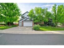 Charming two-story home with a well-manicured lawn and mature trees providing shade at 10356 Lions Heart, Lone Tree, CO 80124