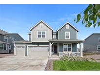 Charming two-story home features a three car garage, well-manicured lawn and a covered front porch at 12826 Lake Port St, Longmont, CO 80504