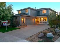 Charming two-story home with a covered porch, attached garage, and well-manicured lawn at 16829 Trail View Cir, Parker, CO 80134