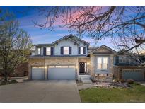 Charming two-story home featuring stone accents, a three-car garage, and a well-manicured lawn in a desirable neighborhood at 6994 S Fultondale Cir, Aurora, CO 80016