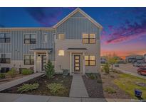 Charming townhome showcasing modern architecture, with landscaped front yard and inviting entrance at 7889 Yampa River Ave, Littleton, CO 80125