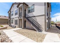 Exterior view of two-story home with staircase leading to second-story entrance at 4605 Copeland Loop # 103, Highlands Ranch, CO 80126