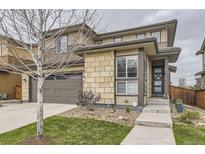 Charming two-story home featuring a two-car garage and stylish stone accents at 14315 Big Stone Dr, Parker, CO 80134
