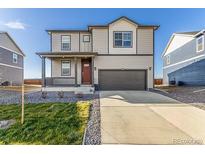 Charming two-story home with a well-manicured lawn and a two-car garage at 2231 Crosswind St, Fort Lupton, CO 80621