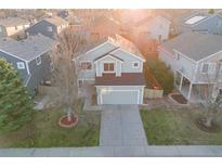 Well-maintained two-story home featuring a manicured front yard and an attached two-car garage at 11223 Jansen St, Parker, CO 80134