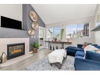 Bright living room featuring a fireplace, vaulted ceilings, and an abundance of natural light at 970 S Dawson Way # 15, Aurora, CO 80012
