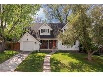 Charming two-story home with a well-manicured front yard and walkway leading to the entrance at 8390 E Davies Pl, Centennial, CO 80112