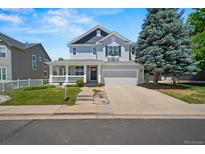 Charming two-story home featuring a welcoming front porch and well-maintained landscaping at 5009 Mt Osage St, Frederick, CO 80504
