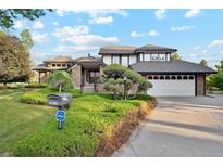 Beautiful two-story home featuring a brick exterior, well-manicured lawn, and attached garage at 10114 Meade Ct, Westminster, CO 80031