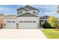 Inviting two-story home with a three-car garage and a well-manicured front yard at 1507 Alpine Ave, Berthoud, CO 80513