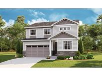 Charming two-story home with gray siding, stone accents, manicured lawn, and attached two car garage at 1431 Lumber Ridge N Cir, Erie, CO 80516