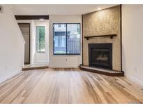 Bright living room featuring a fireplace with decorative tile surround and beautiful wood floors at 2949 Shady Holw, Boulder, CO 80304