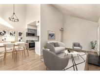 Bright living room features a fireplace and access to a balcony at 3549 S Fairplay Way # 10, Aurora, CO 80014
