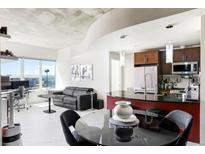 Bright living room featuring modern decor, city views, and an open layout to the kitchen area at 891 14Th St # 2816, Denver, CO 80202