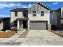 Charming two-story home featuring a two-car garage, stone accents, and a well-maintained lawn at 22037 E 39Th Pl, Aurora, CO 80019