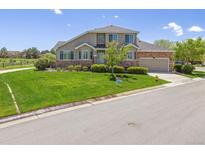 Charming two-story home with a lush green lawn and well-maintained landscaping at 22455 E Plymouth Cir, Aurora, CO 80016