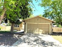 Charming single-story home with a well-manicured lawn and a spacious two-car garage at 16753 E Ithaca Pl, Aurora, CO 80013
