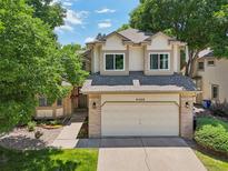 Charming home showcasing a two-car garage, well-manicured lawn, and an inviting exterior at 6468 S Forest St, Centennial, CO 80121