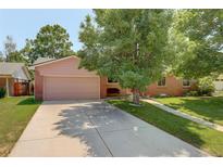 Charming single-story home with a well-manicured front yard and a two-car garage at 2920 S York St, Denver, CO 80210