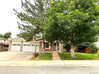 Charming brick home with mature trees and a well-manicured lawn at 3262 S Salida Way, Aurora, CO 80013