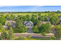 Charming two-story home with a well-manicured lawn and mature trees at 5746 Aspen Creek Dr, Broomfield, CO 80020