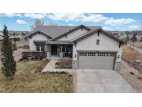 Charming stucco home featuring a two-car garage and stone accents on the front facade at 16500 Crosby Dr, Broomfield, CO 80023