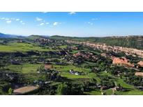 Aerial view of expansive property with houses and scenic landscape at 12768 Grizzly Dr, Littleton, CO 80127