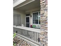Cozy covered patio with stone accents and outdoor seating, perfect for relaxing at 10457 W Hampden Ave # 104, Lakewood, CO 80227