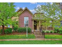 Charming brick home with manicured front yard and inviting entrance at 9580 E 5Th Ave, Denver, CO 80230