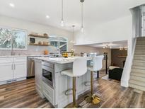 Modern kitchen with stainless steel appliances and an island at 7649 E Amherst Ave, Denver, CO 80231