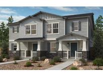 Charming townhouse with gray siding, stone accents, and inviting covered porch at 5231 N Elk St, Aurora, CO 80019