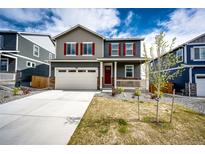 Charming two-story home with gray siding, red shutters, and a well-manicured front lawn at 17955 Sky Pilot Ave, Parker, CO 80134