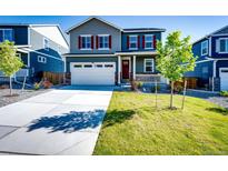 Charming two-story home with a well-manicured lawn and attached two-car garage at 17955 Sky Pilot Ave, Parker, CO 80134