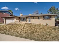 Charming brick ranch-style home with an attached garage and a well-maintained front yard at 2744 S Eaton Way, Denver, CO 80227